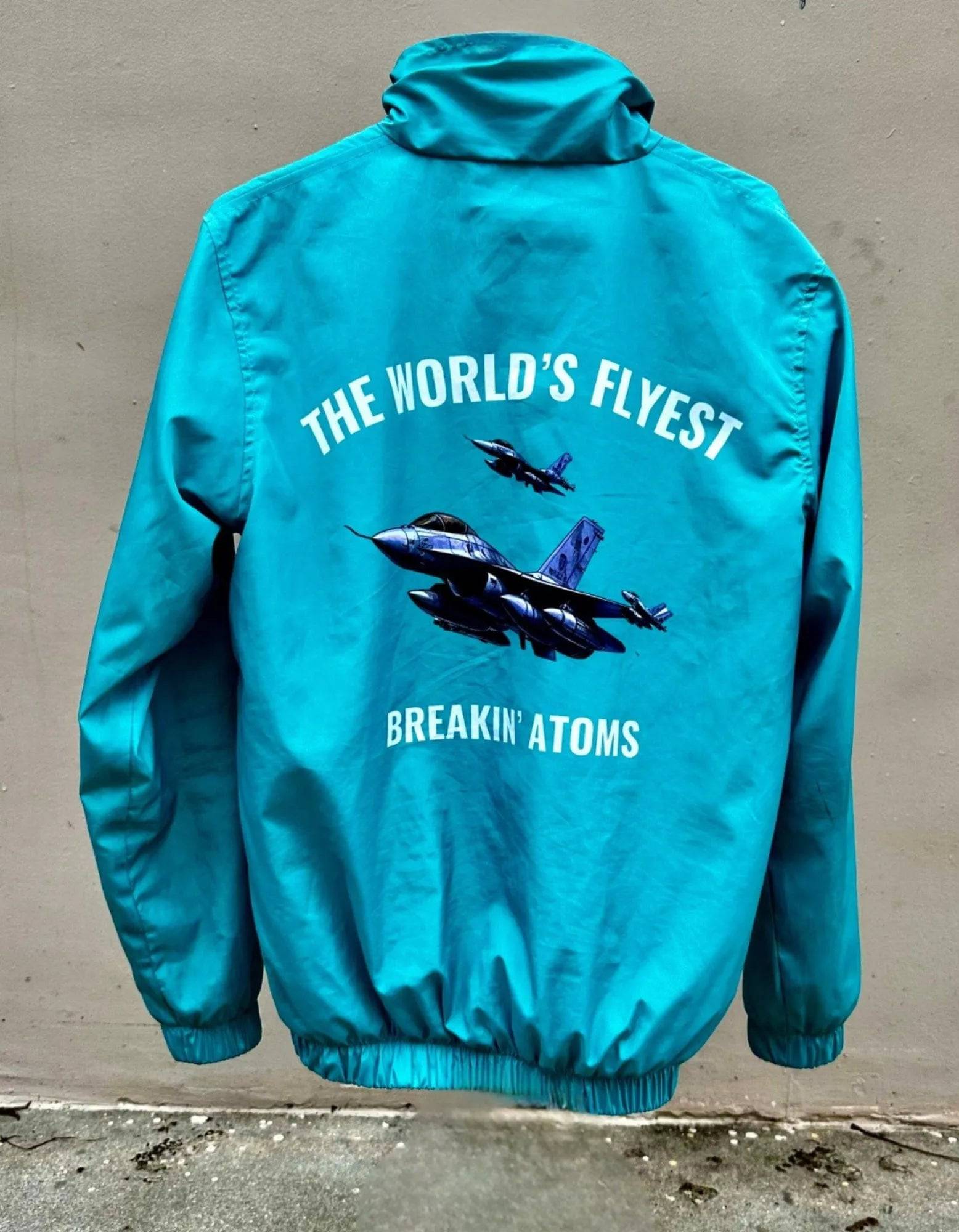 Model wearing Breakin' Atoms "Flyest Windbreaker Jacket" featuring bold color-blocked panels, lightweight zip-up design, and a high-collar fit for retro-inspired streetwear style.