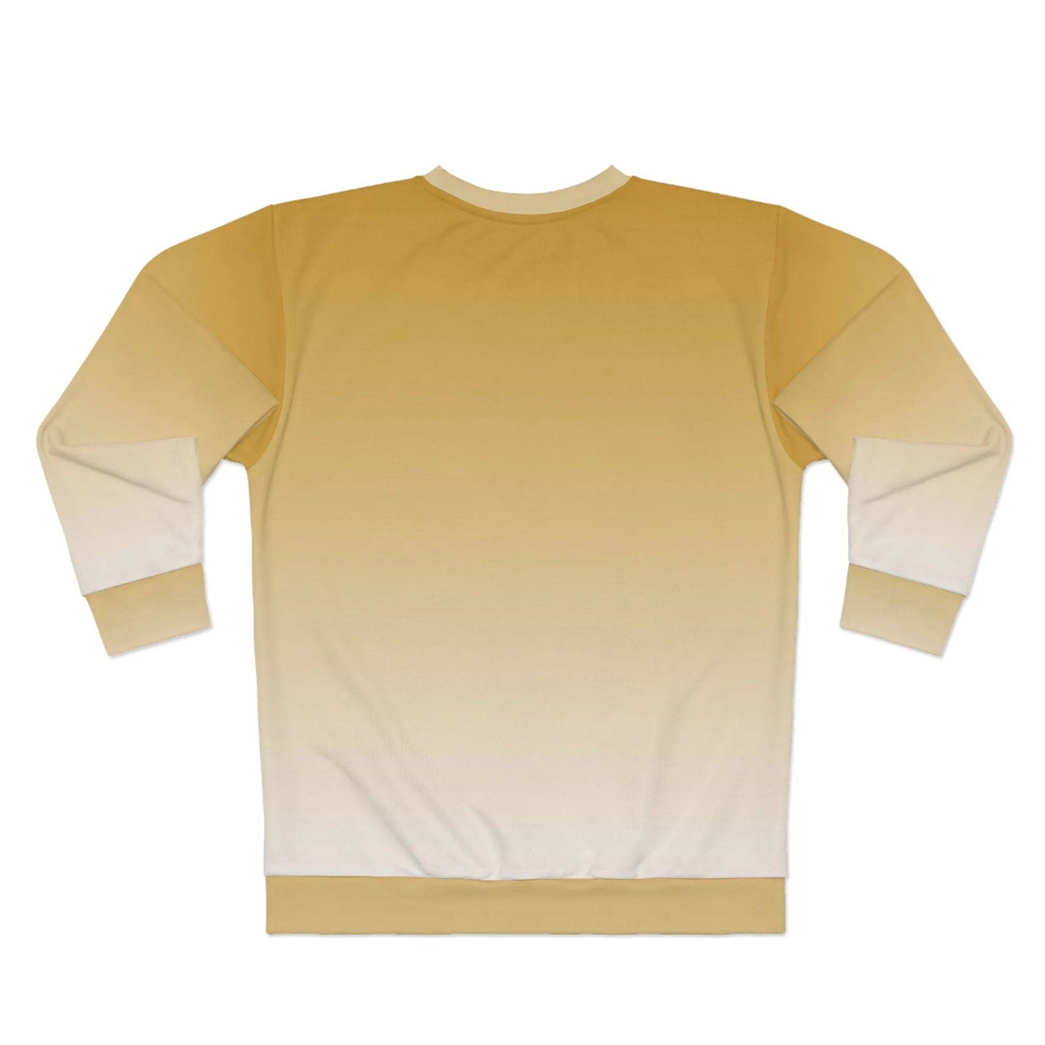 Model wearing Breakin' Atoms "Brown Autumn Sweater," a crewneck sweatshirt with a soft ombré fade from warm golden brown to off-white, finished with a woven logo patch — the perfect blend of cozy and stylish for fall layering.