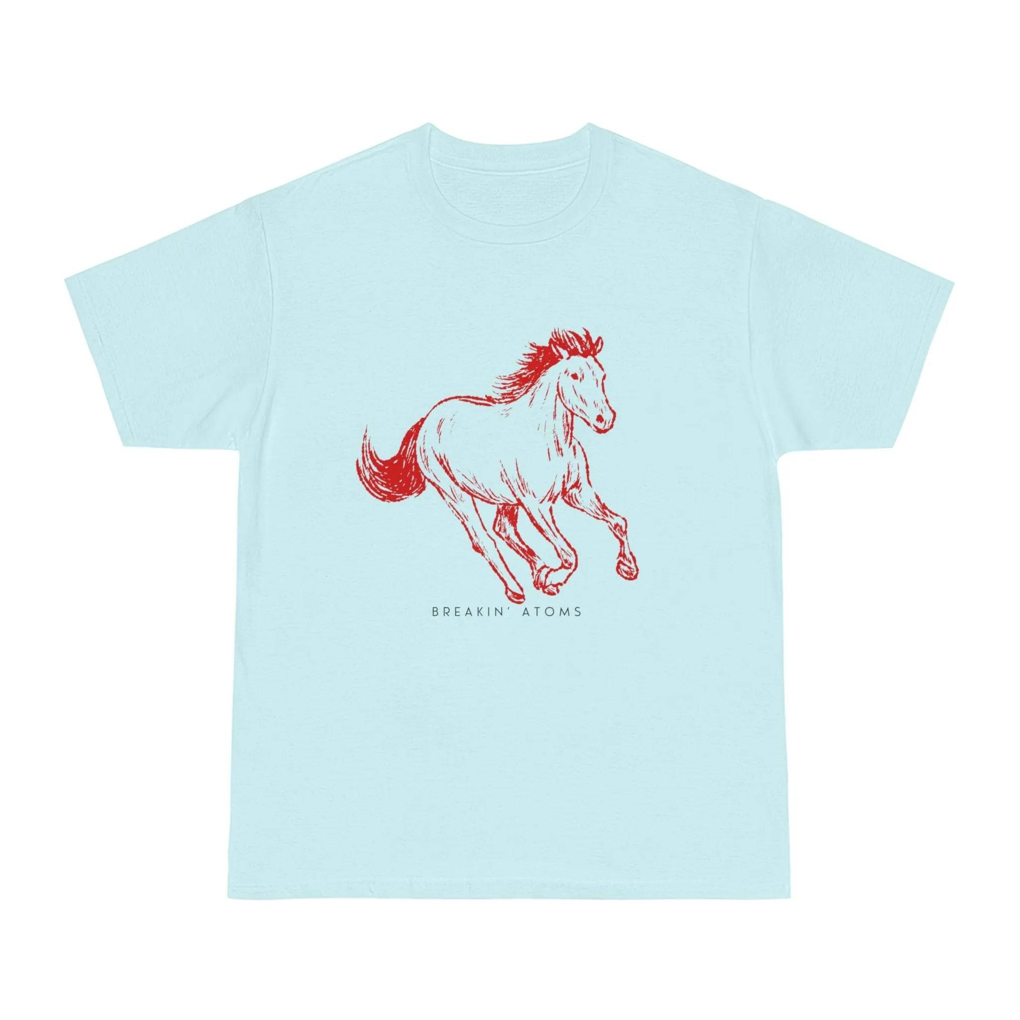 Model wearing Breakin' Atoms "Mustang Spirit Graphic Tee – Freedom Series" in light blue, featuring a red sketch-style mustang in mid-gallop and minimalist Breakin' Atoms logo — a tribute to untamed freedom and movement.