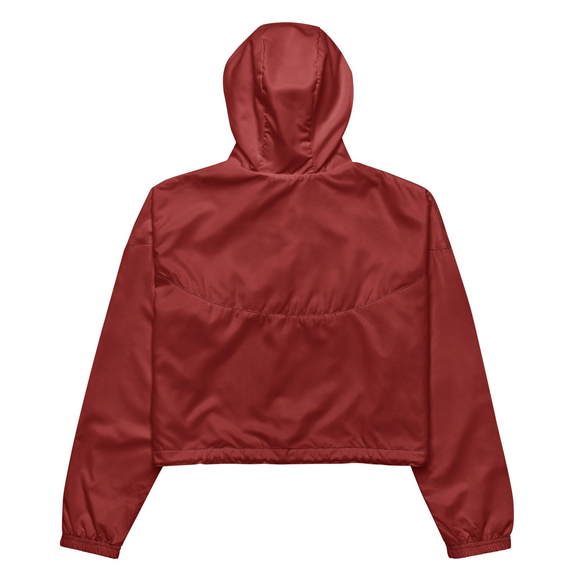 Model wearing Breakin' Atoms "Desert Rose Cropped Windbreaker," a rose-toned lightweight jacket with a cropped cut and adjustable hem — a bold blend of feminine edge and urban utility.