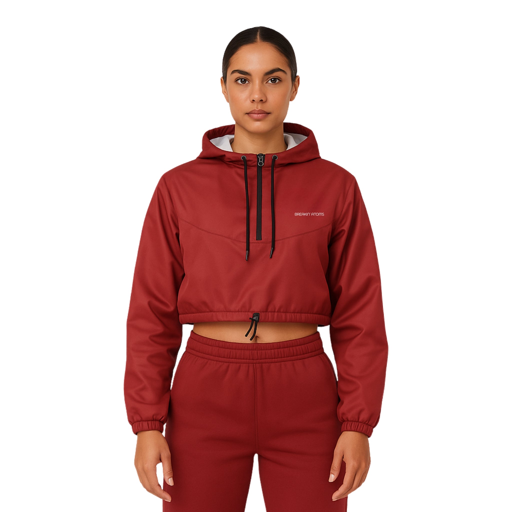 Model wearing Breakin' Atoms "Desert Rose Cropped Windbreaker," a rose-toned lightweight jacket with a cropped cut and adjustable hem — a bold blend of feminine edge and urban utility.