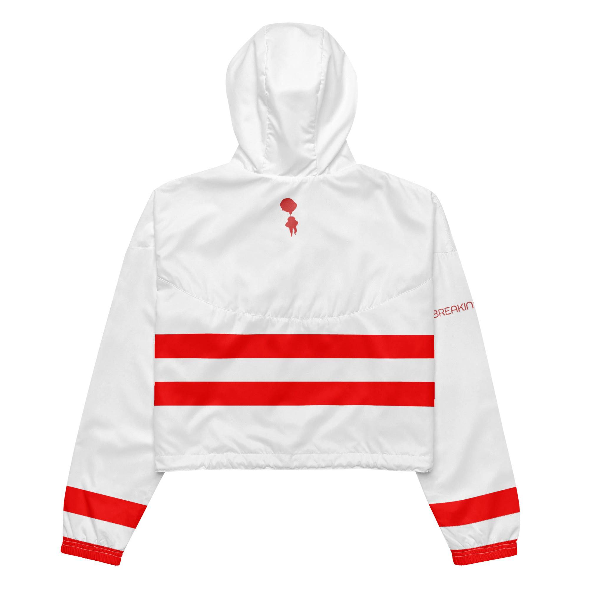 Model wearing Breakin' Atoms "Scarlet Strider Windbreaker" crop top — a vivid red lightweight jacket with a cropped fit, high collar, and zip-up front for bold, sporty streetwear style.