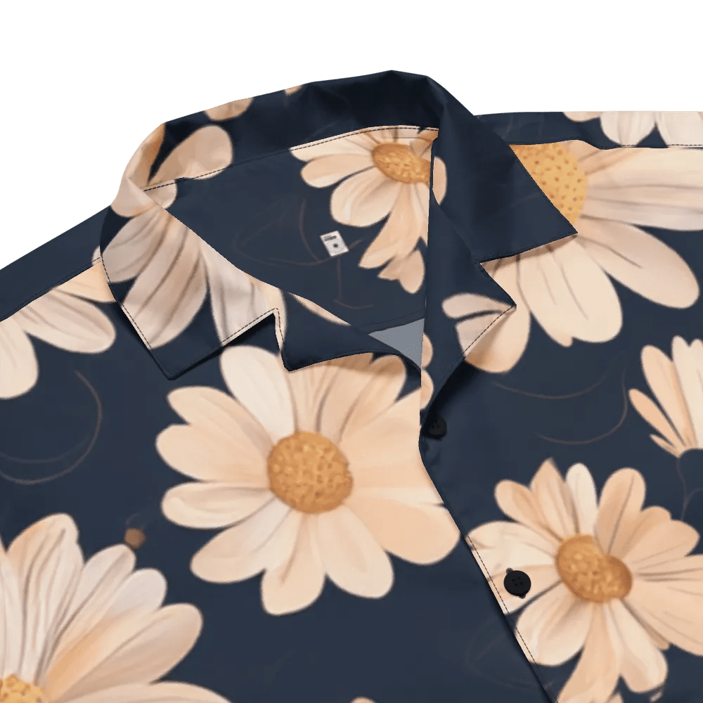 Model wearing Breakin' Atoms "Daydreamer Daisies Shirt," a short-sleeve button-up with an all-over white daisy floral print — perfect for spring vibes, casual weekends, and expressive streetwear.