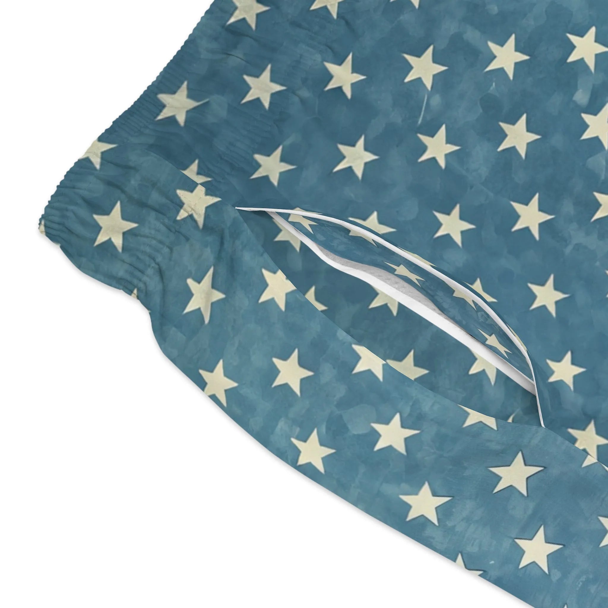 Model wearing Breakin' Atoms "Star-Spangled Shorts," featuring a bold navy blue and cream color block design with scattered star prints — a modern twist on patriotic fashion perfect for summer and festival wear.