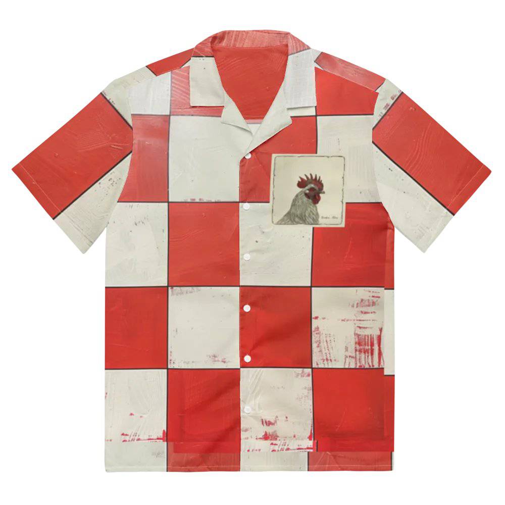 Model wearing Breakin' Atoms "Big Rooster Shirt," a short-sleeve dress shirt with oversized red and cream checkerboard print and a bold rooster graphic on the chest pocket.