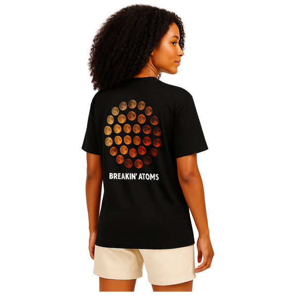 Woman wearing Phases by Breakin' Atoms black t-shirt with lunar cycle graphic and white logo on back