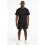 Model wearing Breakin' Atoms "Aurora Drops Shorts," featuring a vibrant, colorful drip-print inspired by the aurora borealis — a statement streetwear piece with cosmic energy and movement. thumbnail 1