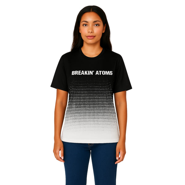Model wearing Breakin' Atoms "Checker Charger Tee" — a racing-inspired streetwear t-shirt featuring bold checkerboard design, retro type graphics, and high-energy color contrast for a full-throttle aesthetic.