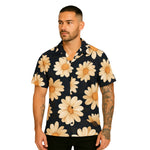 Model wearing Breakin' Atoms "Daydreamer Daisies Shirt," a short-sleeve button-up with an all-over white daisy floral print — perfect for spring vibes, casual weekends, and expressive streetwear. thumbnail 1