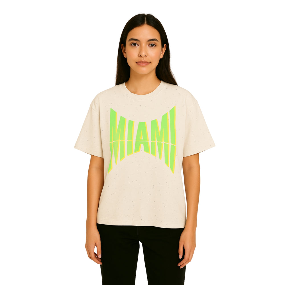 Model wearing Breakin' Atoms "Miami" Tee in off-white, featuring a bold neon green warped 'MIAMI' graphic across the chest, in a relaxed fit. — Breakin Atoms premium streetwear