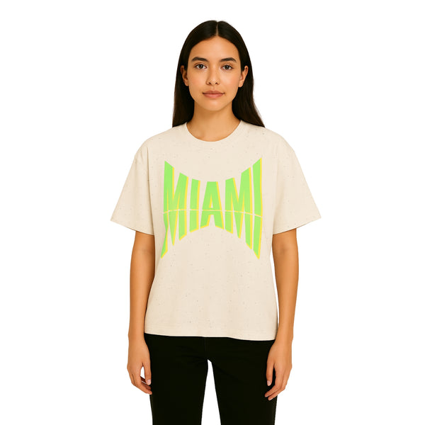 Model wearing Breakin' Atoms "Miami" Tee in off-white, featuring a bold neon green warped 'MIAMI' graphic across the chest, in a relaxed fit.