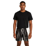 Model wearing Breakin' Atoms "Monochrome Strike Shorts," black and white split-panel shorts with vertical stripe detailing and signature branding — combining clean minimalism with sharp streetwear edge. thumbnail 1