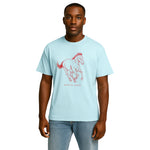 Model wearing Breakin' Atoms "Mustang Spirit Graphic Tee – Freedom Series" in light blue, featuring a red sketch-style mustang in mid-gallop and minimalist Breakin' Atoms logo — a tribute to untamed freedom and movement. thumbnail 1