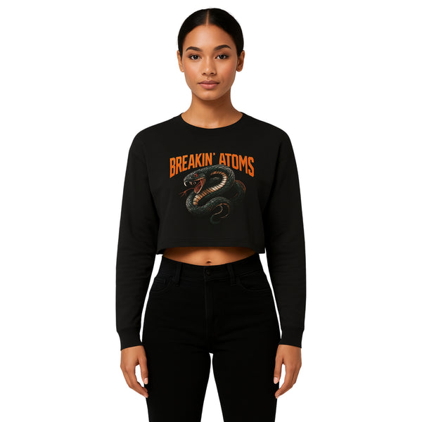 Model wearing Breakin’ Atoms "Serpent Strike Crop Top" — a bold, fitted cropped tee featuring a striking serpent graphic and clean typography, blending mystique, power, and sharp streetwear style.