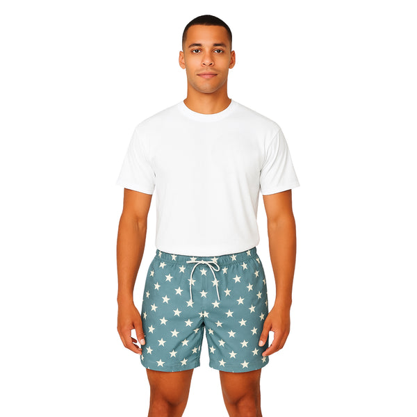 Model wearing Breakin' Atoms "Star-Spangled Shorts," featuring a bold navy blue and cream color block design with scattered star prints — a modern twist on patriotic fashion perfect for summer and festival wear.