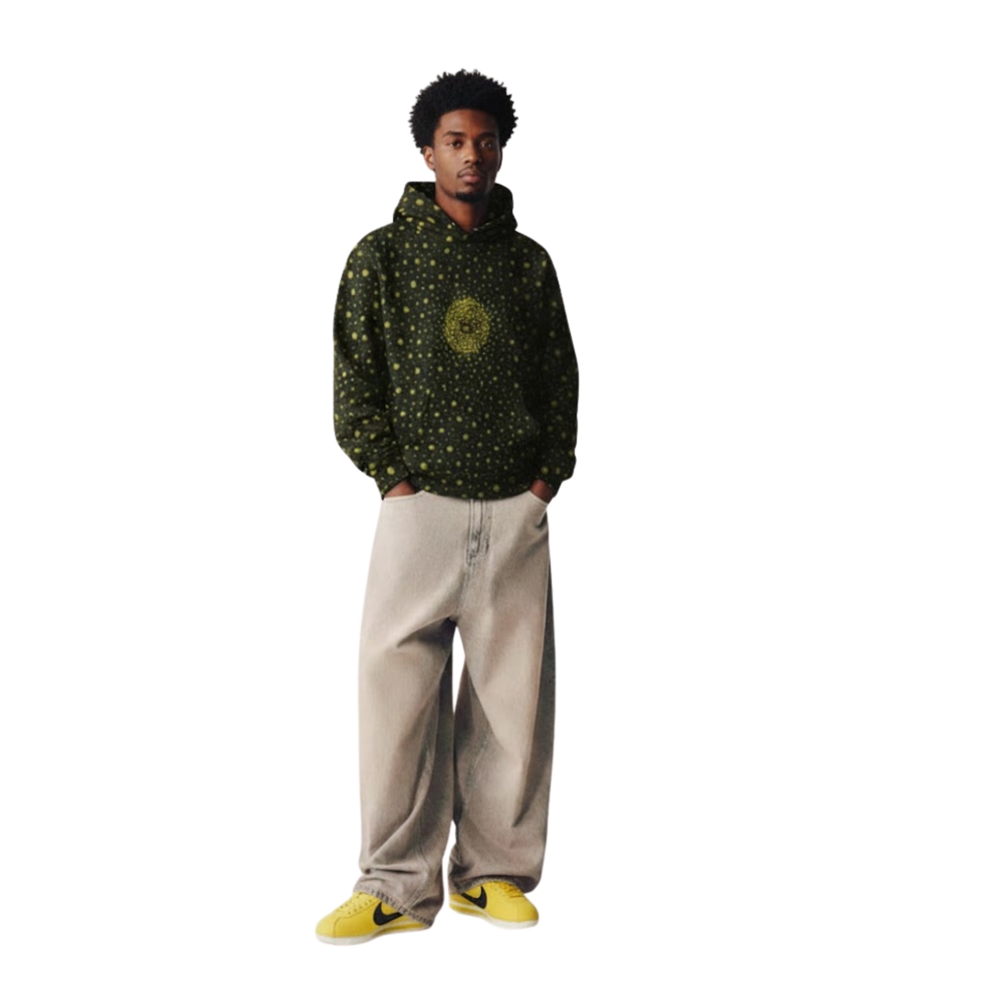 “Model wearing the Breakin’ Atoms VRAY Hoodie featuring a green stingray-inspired dot pattern with a central flare motif, shown from the front with hands in pockets.”